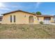 Charming single-story home featuring a stucco exterior, decorative gate, and a well-maintained front yard at 7035 Cutty Sark Dr, Port Richey, FL 34668