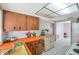 Bright kitchen with wooden cabinets, tile backsplash, and ample counter space at 7035 Cutty Sark Dr, Port Richey, FL 34668