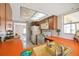 Open kitchen layout with white appliances, orange countertops, and natural lighting at 7035 Cutty Sark Dr, Port Richey, FL 34668