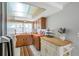 Charming kitchen featuring wooden cabinets and a cozy decorative elements at 7035 Cutty Sark Dr, Port Richey, FL 34668