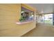 Relaxing enclosed lanai with pass through window, offering a serene view of the backyard and neighborhood at 7035 Cutty Sark Dr, Port Richey, FL 34668