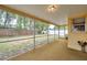 Enclosed lanai showcasing a peaceful outdoor retreat with screened windows and a backyard view at 7035 Cutty Sark Dr, Port Richey, FL 34668