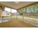 Cozy enclosed lanai offers a tranquil view of the backyard, blending indoor and outdoor living at 7035 Cutty Sark Dr, Port Richey, FL 34668