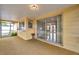 Enclosed lanai featuring a sliding glass door, pass through window to the main home, and a tranquil view at 7035 Cutty Sark Dr, Port Richey, FL 34668