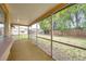 Relaxing enclosed lanai with views of the backyard and mature trees, providing a peaceful escape at 7035 Cutty Sark Dr, Port Richey, FL 34668
