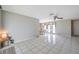 Airy living room featuring tile floors, neutral paint, ceiling fan, and a view of the dining space at 7035 Cutty Sark Dr, Port Richey, FL 34668