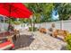 Private backyard oasis with a spacious patio, lush landscaping, and charming seating areas at 713 715 W Fribley St, Tampa, FL 33603