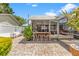 Outdoor bar and patio area including white seating, lush plants, and a screened-in porch entrance at 713 715 W Fribley St, Tampa, FL 33603