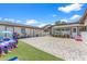 Bright backyard features a tiled patio area with artificial grass and is equipped with play structures for children at 713 715 W Fribley St, Tampa, FL 33603