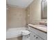 Bathroom with a shower-tub combo and a vanity featuring a granite countertop at 713 715 W Fribley St, Tampa, FL 33603