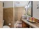 Bathroom featuring granite counters, glass enclosed shower, and modern fixtures at 713 715 W Fribley St, Tampa, FL 33603