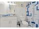 The bathroom has a patterned shower curtain, single sink vanity, and bright lighting at 713 715 W Fribley St, Tampa, FL 33603