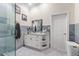 Modern bathroom with a marble vanity, walk-in shower, and contemporary fixtures at 713 715 W Fribley St, Tampa, FL 33603