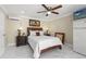 This cozy bedroom features a ceiling fan, a TV, warm lighting, and a comfortable bed at 713 715 W Fribley St, Tampa, FL 33603