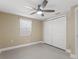 Bedroom featuring tiled floors, a closet, ceiling fan, and natural light from the window at 713 715 W Fribley St, Tampa, FL 33603