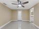 Bedroom featuring tiled floors, ceiling fan, and an open doorway to the bathroom at 713 715 W Fribley St, Tampa, FL 33603