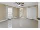Bedroom features tiled floors, ceiling fan, a closet, and an open doorway to the bathroom at 713 715 W Fribley St, Tampa, FL 33603