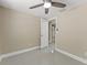 Bedroom featuring tiled floors, ceiling fan, and an open doorway to the bathroom at 713 715 W Fribley St, Tampa, FL 33603