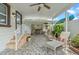 Charming covered patio with stone flooring, comfortable lounge chairs, and a built-in outdoor kitchen at 713 715 W Fribley St, Tampa, FL 33603