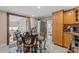 Dining area featuring a round table with seating, wood cabinets, and stainless steel refrigerator at 713 715 W Fribley St, Tampa, FL 33603