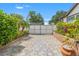 A long tiled driveway with an automated security gate adds elegance and privacy at 713 715 W Fribley St, Tampa, FL 33603