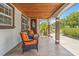 Inviting front porch with comfortable seating, decorative tile flooring, and detailed columns at 713 715 W Fribley St, Tampa, FL 33603