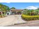 Charming single-story home with well-manicured landscaping, lush plants and concrete driveway at 713 715 W Fribley St, Tampa, FL 33603