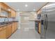 Updated kitchen with granite counters, stainless steel appliances, and tile backsplash at 713 715 W Fribley St, Tampa, FL 33603