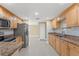 Bright kitchen featuring granite countertops, stainless steel appliances, and tile flooring at 713 715 W Fribley St, Tampa, FL 33603