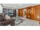 Comfortable living room featuring a cozy leather sofa, built-in shelves, and tile flooring at 713 715 W Fribley St, Tampa, FL 33603