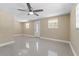 Bright living room featuring tiled floors, a modern ceiling fan, and a welcoming front door at 713 715 W Fribley St, Tampa, FL 33603