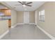 Spacious living room featuring tile floors, a ceiling fan, and access to kitchen at 713 715 W Fribley St, Tampa, FL 33603