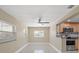 Open-concept living room with a ceiling fan and view into the kitchen at 713 715 W Fribley St, Tampa, FL 33603