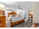 Serene main bedroom with a wooden bed frame, ceiling fan, and en-suite bathroom entrance at 713 715 W Fribley St, Tampa, FL 33603