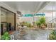 Covered outdoor patio with stone floors, seating, and green plants at 713 715 W Fribley St, Tampa, FL 33603