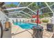 Screened-in pool with crystal clear blue water, ample deck space, and decorative accents for relaxation and entertainment at 713 715 W Fribley St, Tampa, FL 33603