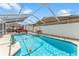 Sparkling in-ground pool surrounded by a screened enclosure and a well-kept backyard at 713 715 W Fribley St, Tampa, FL 33603