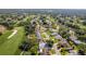 A beautiful aerial shot of 7499 Blue Skies Dr home nestled in a lush, green neighborhood close to the golf course at 7499 Blue Skies Dr, Spring Hill, FL 34606