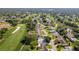 Gorgeous aerial view of houses lining the golf course at The Country Club of the Pines in Spring Hill, Florida at 7499 Blue Skies Dr, Spring Hill, FL 34606