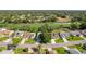 Community aerial view with manicured lawns, mature trees, and golf course at The Country Club of the Pines at 7499 Blue Skies Dr, Spring Hill, FL 34606