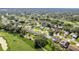 Aerial view of the community showcases golf course homes and lush landscaping throughout Spring Hill at 7499 Blue Skies Dr, Spring Hill, FL 34606
