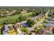 Great aerial view of a neighborhood with mature trees and lush lawns at 7499 Blue Skies Dr, Spring Hill, FL 34606