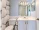 A full bathroom offers storage and a golf ball shower curtain to match the community at 7499 Blue Skies Dr, Spring Hill, FL 34606