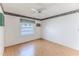 Empty bedroom with light wood floors, a ceiling fan, and natural light from the window at 7499 Blue Skies Dr, Spring Hill, FL 34606