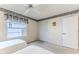 A carpeted bedroom has twin beds, a closet, and a window with peaceful views at 7499 Blue Skies Dr, Spring Hill, FL 34606