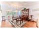 Dining room with chandelier, wood table and chairs, china cabinet and access to sunroom at 7499 Blue Skies Dr, Spring Hill, FL 34606