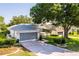 Charming single-story home with well-manicured landscaping and a two-car garage in The Country Club of the Pines at 7499 Blue Skies Dr, Spring Hill, FL 34606