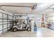 Garage equipped with an automatic door opener, storage, work space, and room for a golf cart at 7499 Blue Skies Dr, Spring Hill, FL 34606