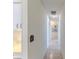 Hallway with tile flooring leading to rooms, with a glimpse of the kitchen at 7499 Blue Skies Dr, Spring Hill, FL 34606