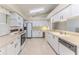 Spacious kitchen featuring white cabinets, tile floor, and modern appliances at 7499 Blue Skies Dr, Spring Hill, FL 34606